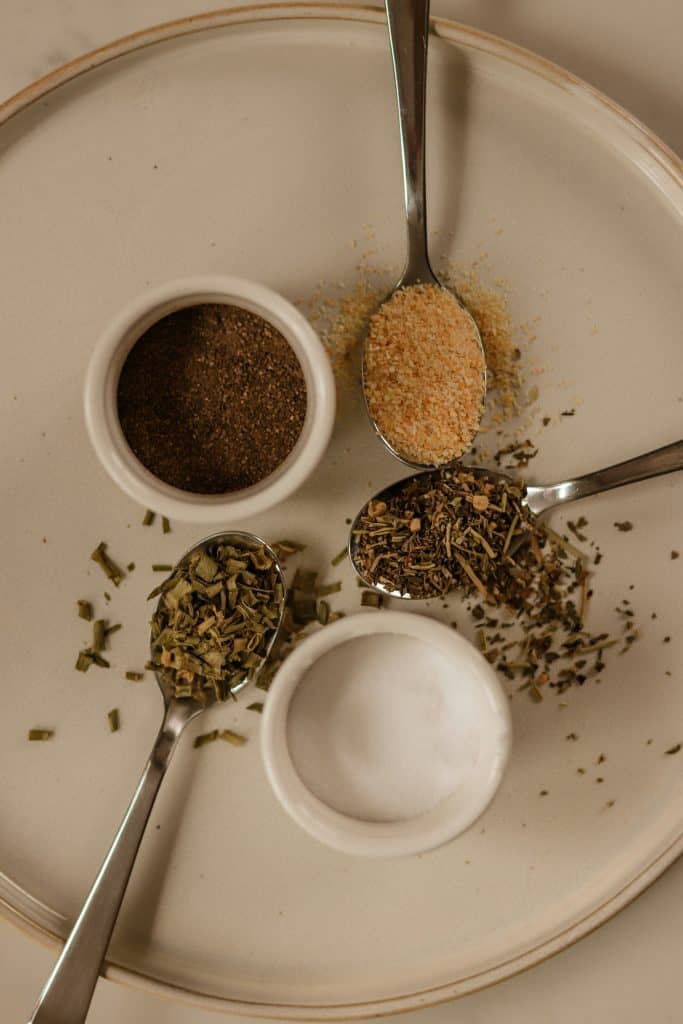 Ready2Eat Spices and Seasonings Assorted spices and seasonings on a white plate for meal preparation.